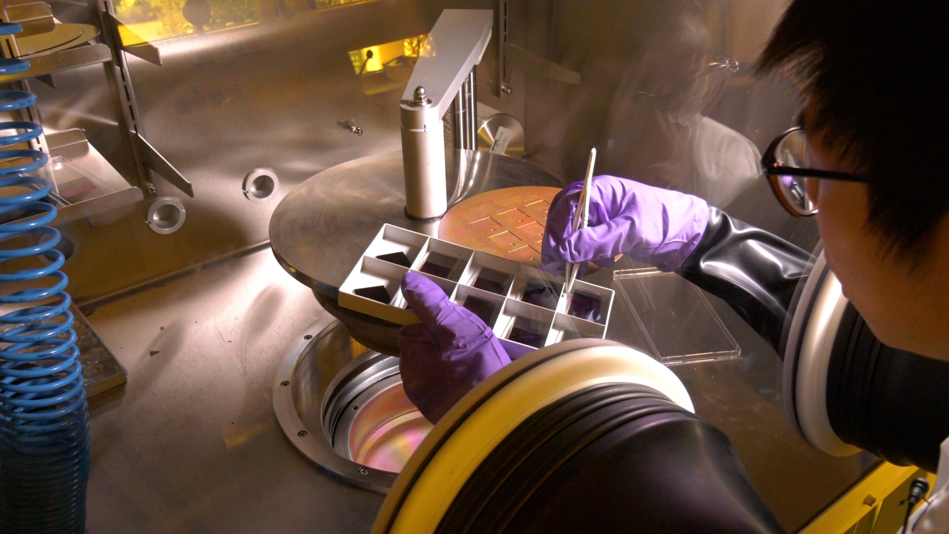 A scientist working on an experiment in a fume cupboard